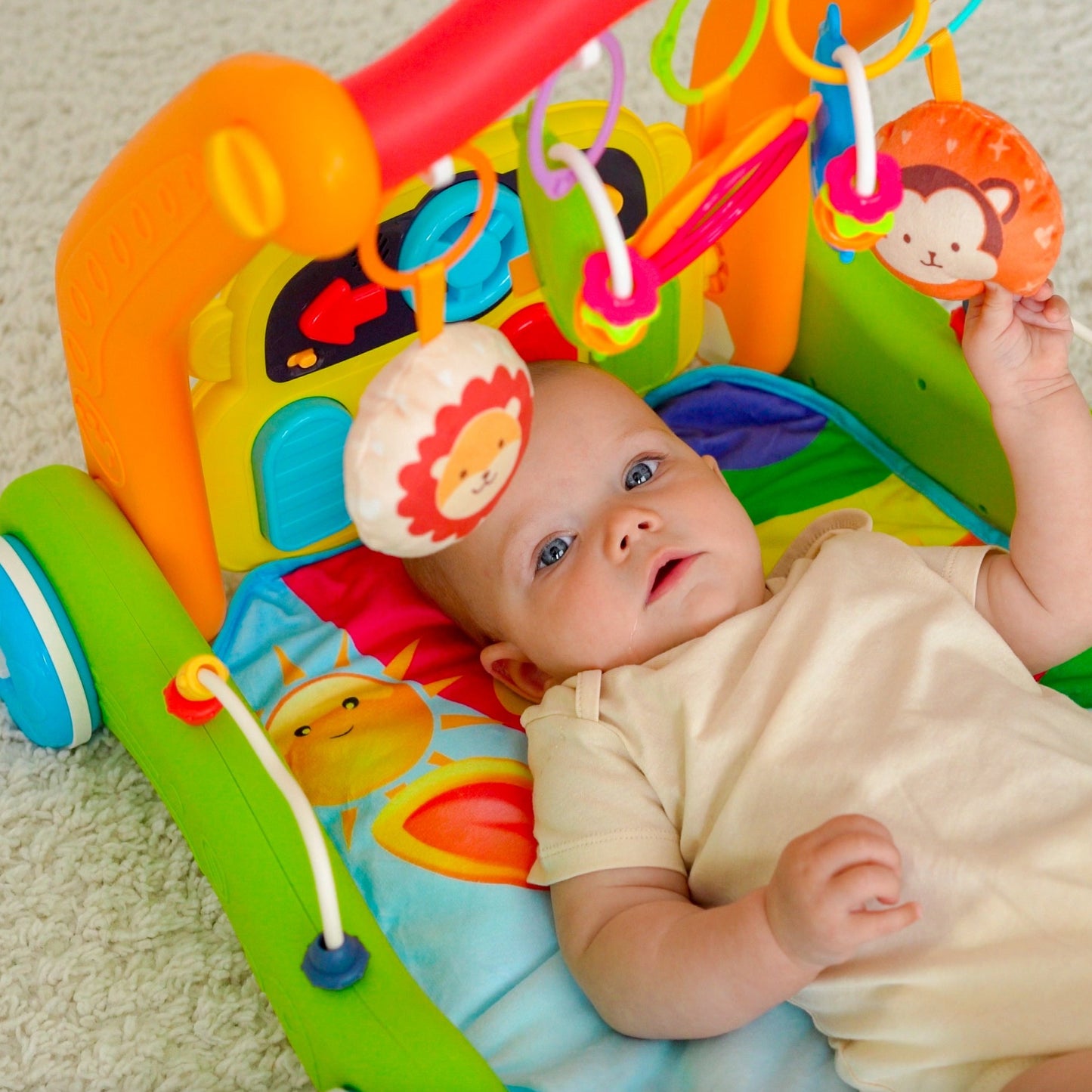 4-in-1 baby activity center for tummy time, sitting, learning to walk, and on-the-go fun. Features over 30 sounds & songs including ABC’s and Wheels on the Bus. Includes 4 rattles, a mirror, and a piano for interactive play and exploration. Lead-free materials ensure safety exceeds US and EU toy regulations. Packaged for gifting, easy assembly, and machine washable mat. Requires 2xAAA batteries (not included).