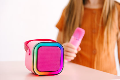 Kids Mini Karaoke Machine featuring 20+ pre-loaded kid songs like Twinkle Twinkle Little Star and Wheels on the Bus. Connects to phone or tablet via Bluetooth for playing songs from Spotify, YouTube, and Apple Music. Portable, durable design perfect for playdates and open mic nights. Includes 4 voice effects and echo mode for quality sound. Rechargeable battery provides up to 6 hours of playtime.