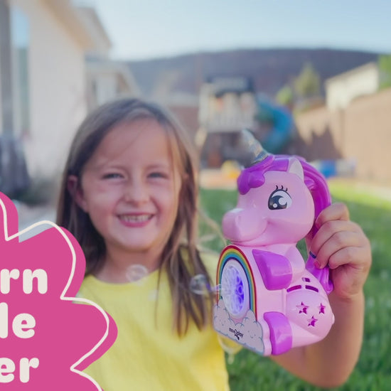 Child holding unicorn bubble blower toy with batteries and bubble solution included. Handheld design with durable, water-resistant features and easy-grip handle. Produces thousands of bubbles per minute for fun-filled occasions like birthdays and playdates.