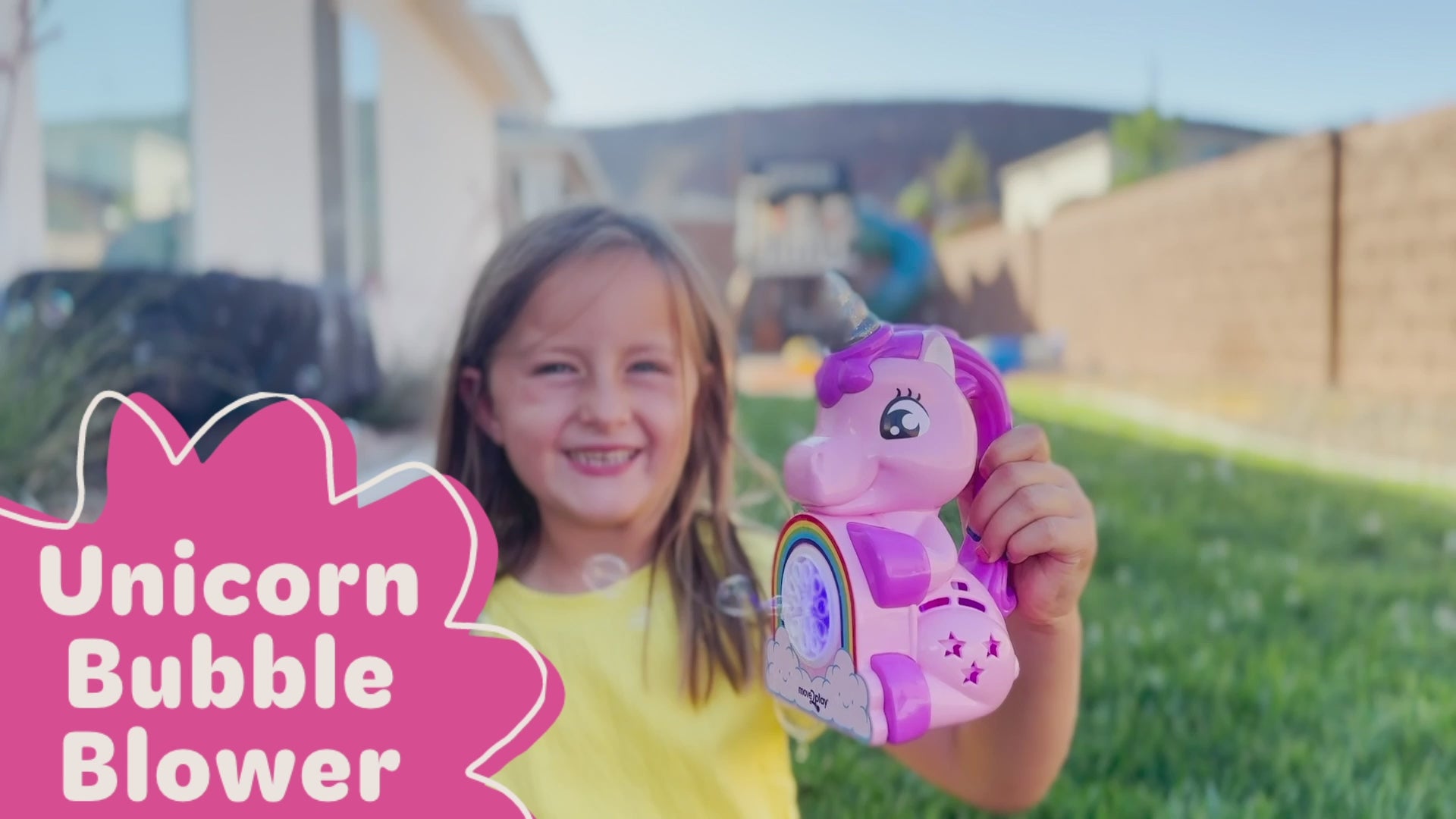 Child holding unicorn bubble blower toy with batteries and bubble solution included. Handheld design with durable, water-resistant features and easy-grip handle. Produces thousands of bubbles per minute for fun-filled occasions like birthdays and playdates.